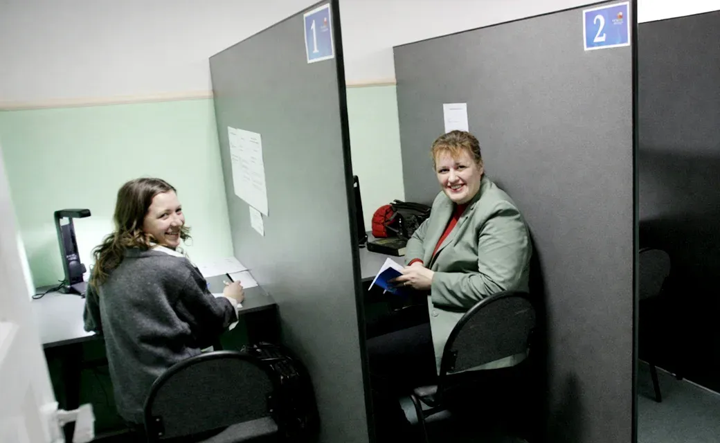 Call center counselors at phone cubicles.