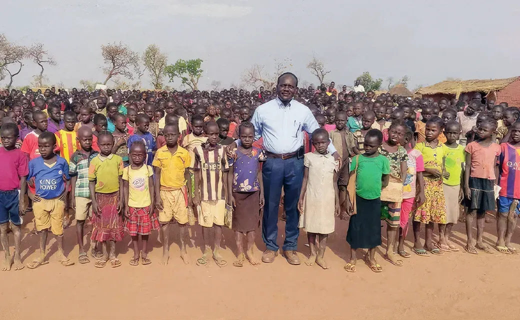 Community leader Mari with children in South Sudan, supporting local clinics that provide medical care and medicine.