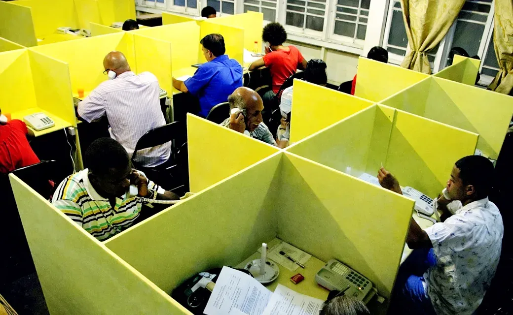 Call centre team in Guyana answering phones in individual stations.