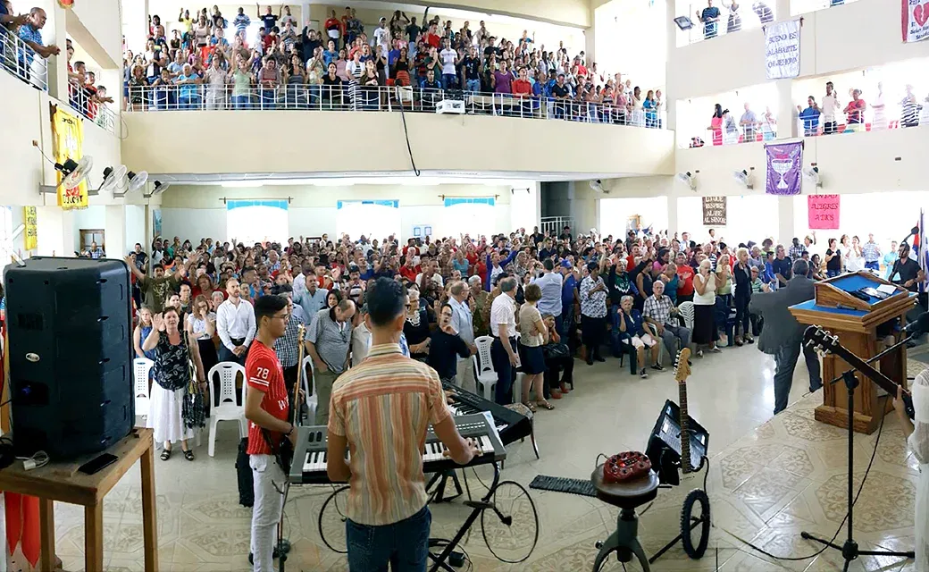 Large church sanctuary filled with people standing during a service.