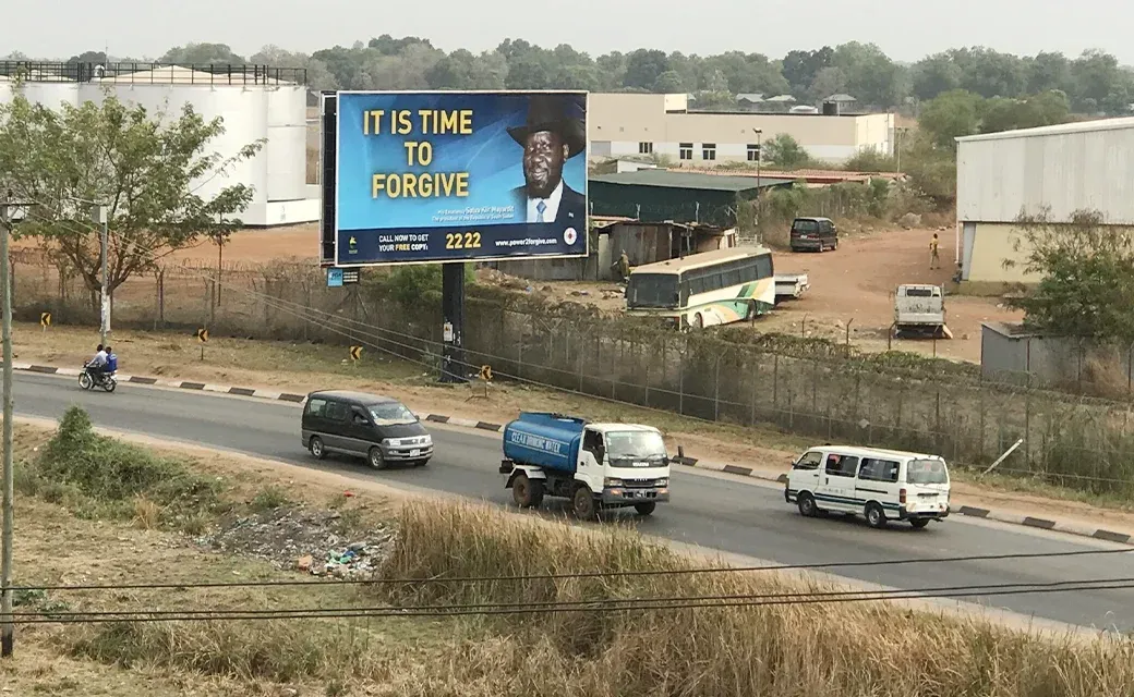 Juba roadside billboard with the ‘It Is Time to Forgive’ campaign message near a highway.