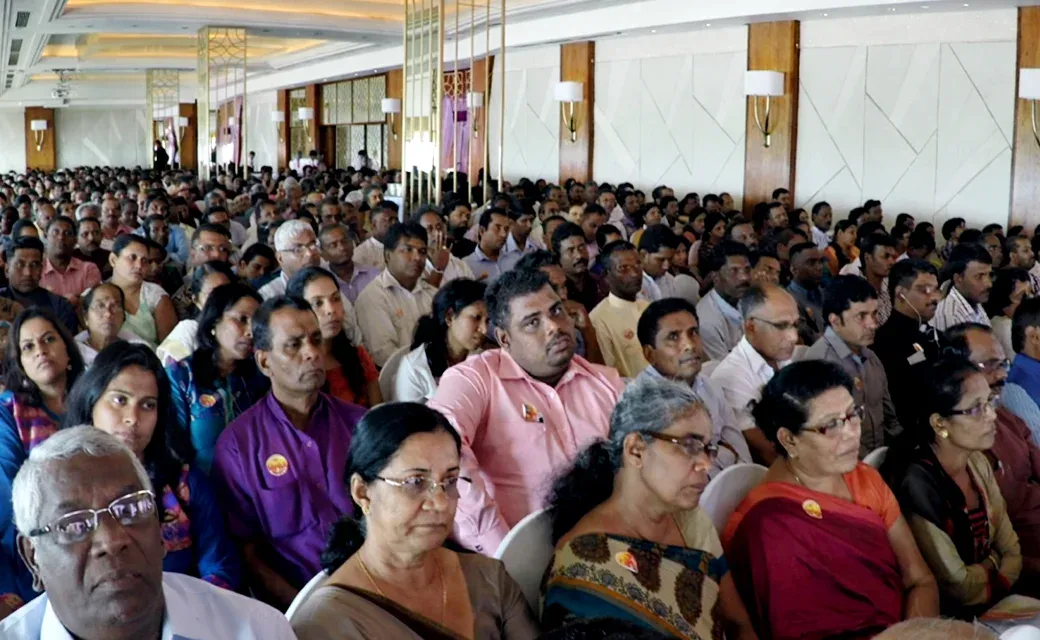 Large audience seated at a gathering in Sri Lanka.
