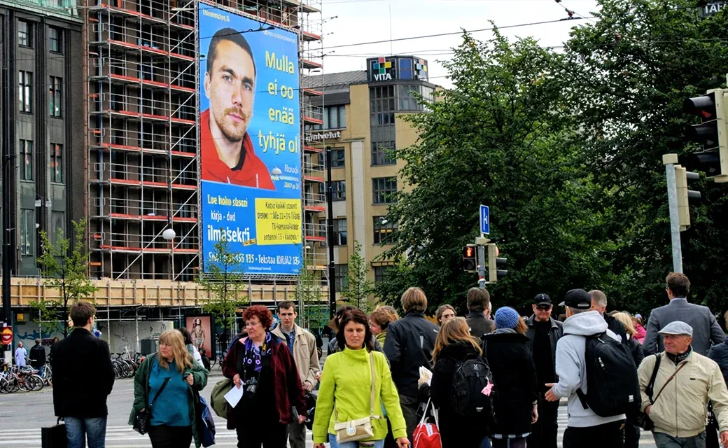 A large outdoor campaign advertisement displayed in the Helsinki area.